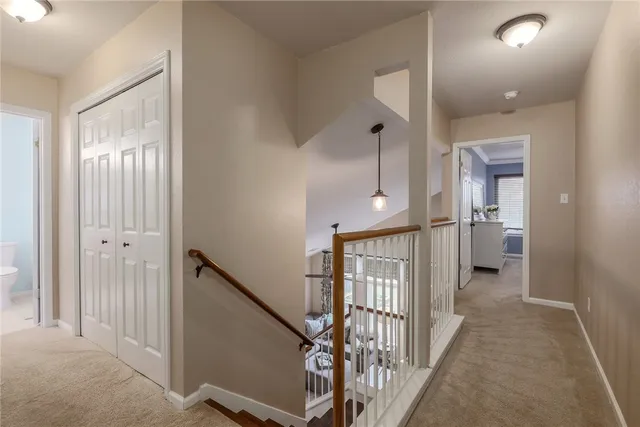 a view of a hallway with windows and stairs