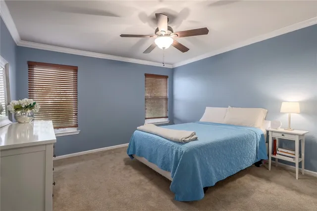 a spacious bedroom with a bed and a window