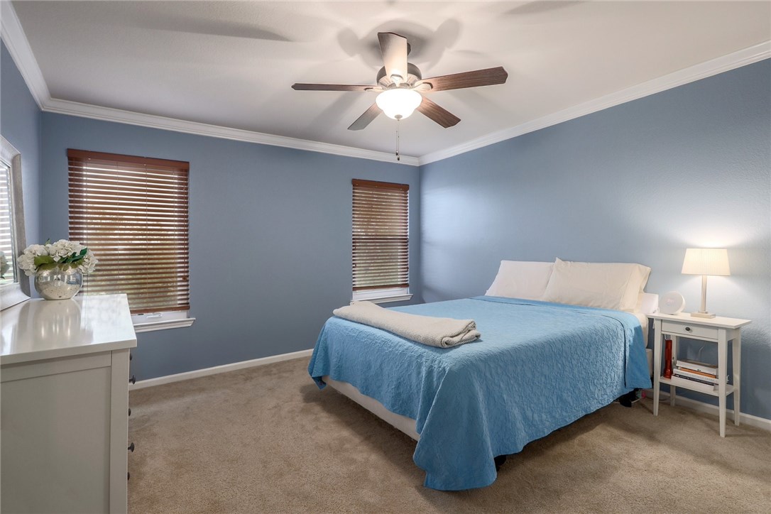 7908 Portland Trail Austin, TX 78729 - Photo 15 of 35 a spacious bedroom with a bed and a window