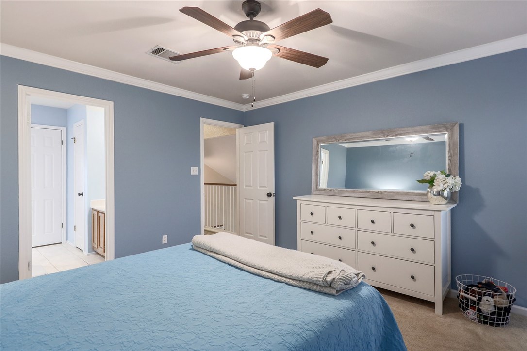 7908 Portland Trail Austin, TX 78729 - Photo 16 of 35 a bedroom with a bed and a dresser