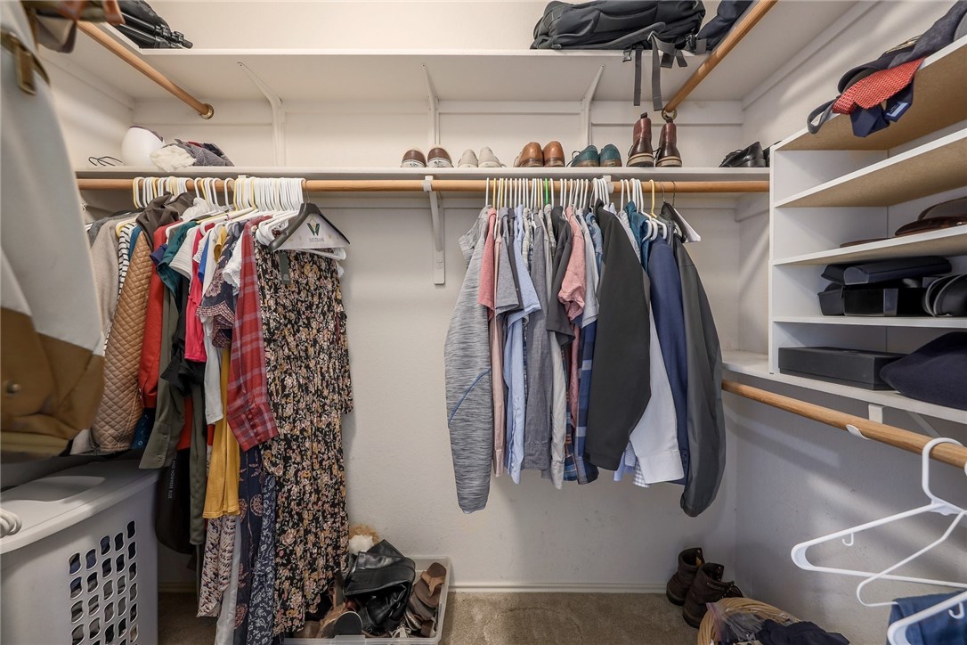 7908 Portland Trail Austin, TX 78729 - Photo 19 of 35 a view of walk in closet with clothes and shoes