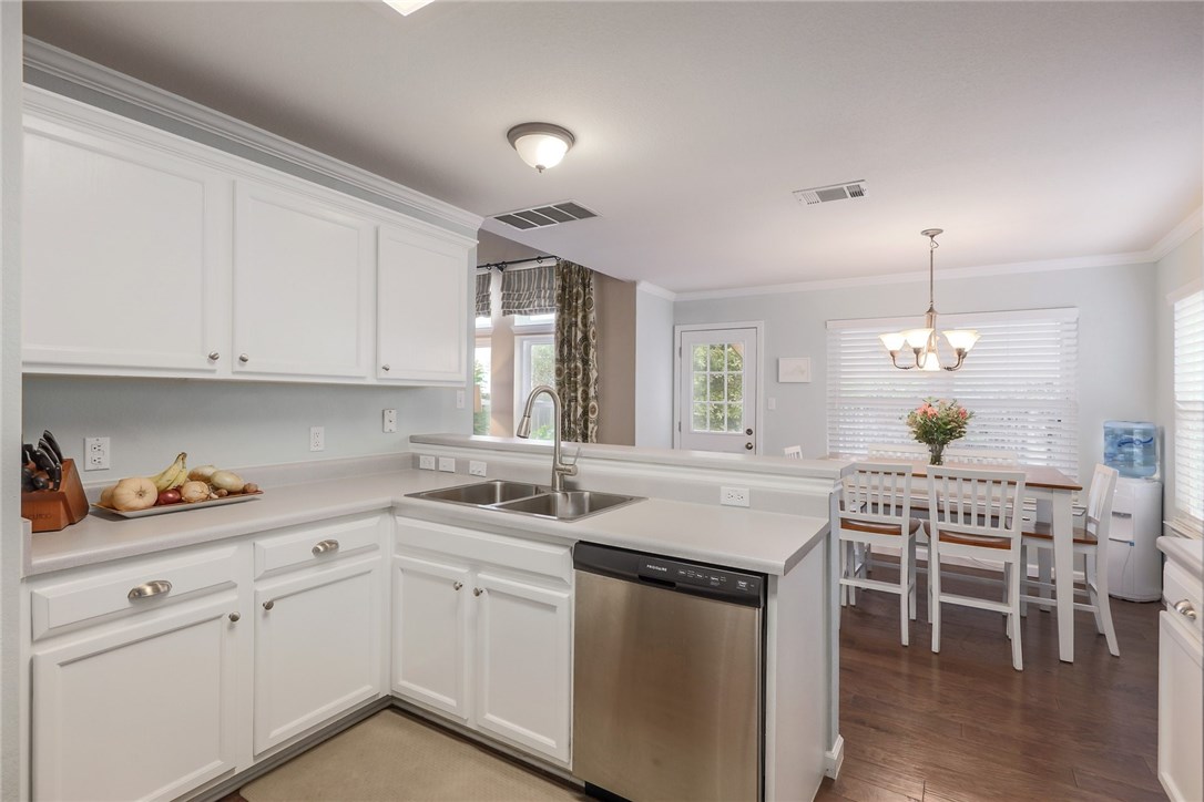 7908 Portland Trail Austin, TX 78729 - Photo 2 of 35 a kitchen with white cabinets and sink