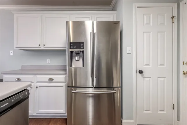 a white refrigerator freezer and a stove sitting inside of a kitchen