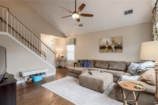 a living room with furniture and a view of bedroom