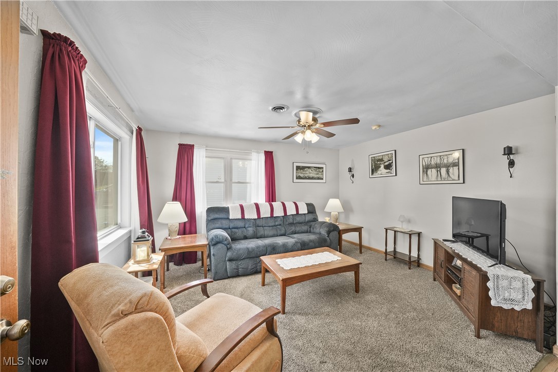 6677 Fee Road Rome, OH 44085 - Photo 9 of 39 Carpeted living room with ceiling fan