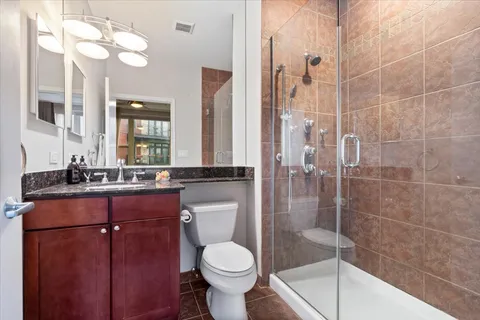 a bathroom with a sink toilet and shower