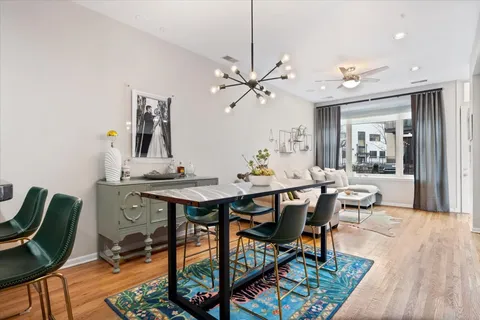a view of a a dining room with furniture window and wooden floor