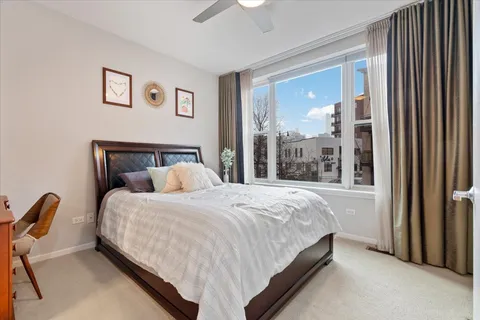 a large bed sitting in a bedroom next to a window