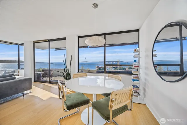 a dining room with furniture and a floor to ceiling window