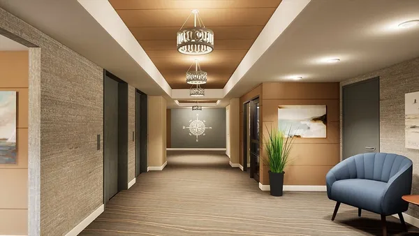 a view of a hallway with furniture and a chandelier