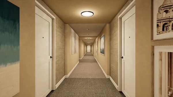 a view of a hallway with wooden floor and a bathroom