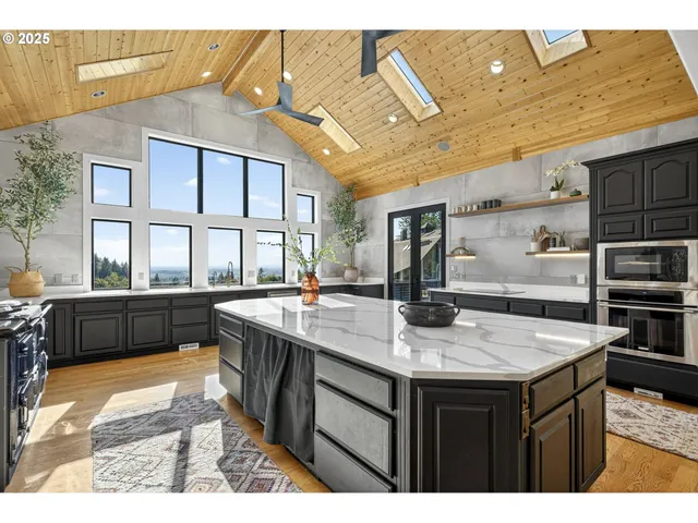 a kitchen with stainless steel appliances granite countertop a sink and wooden cabinets