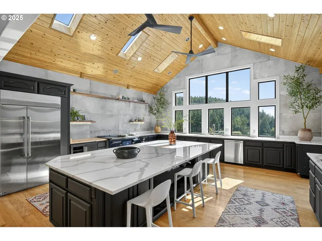 a kitchen with a stove a sink and a dining table