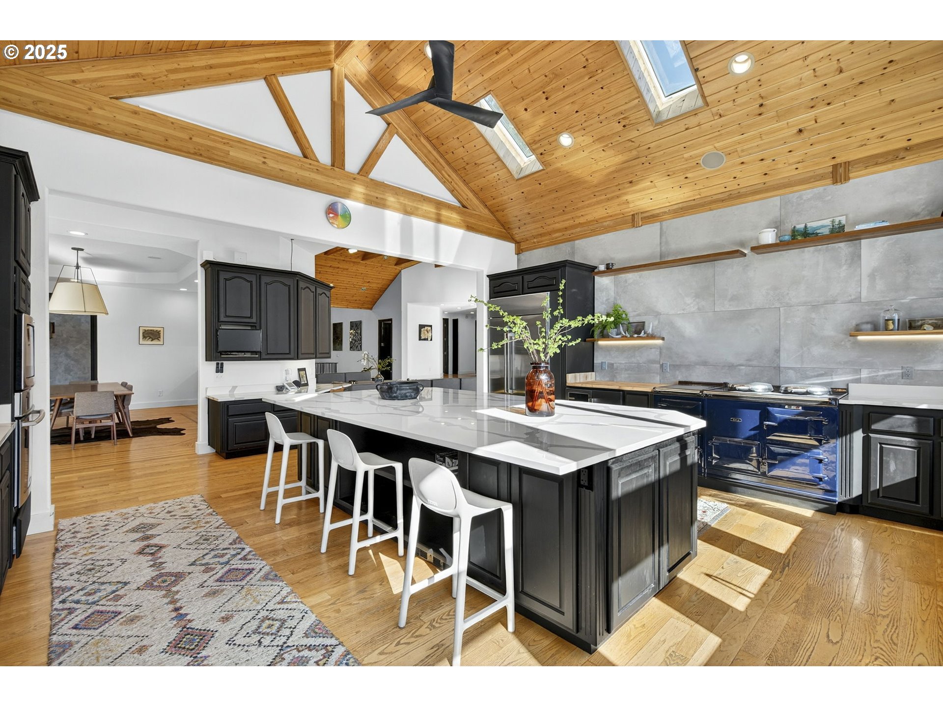 32520 Northeast Corral Creek Road Newberg, OR 97132 - Photo 13 of 48 a kitchen with stainless steel appliances granite countertop a stove a sink dishwasher and a dining table with the view of living room