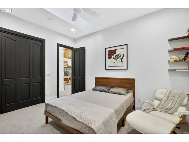 a bedroom with a bed and a painting on the wall