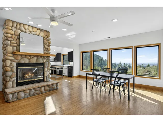 a living room with furniture a large window and a fireplace