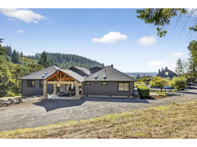 a front view of a house with a garden and pathway