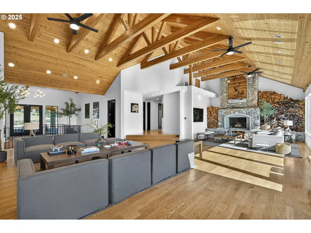 a living room with fireplace furniture and a wooden floor