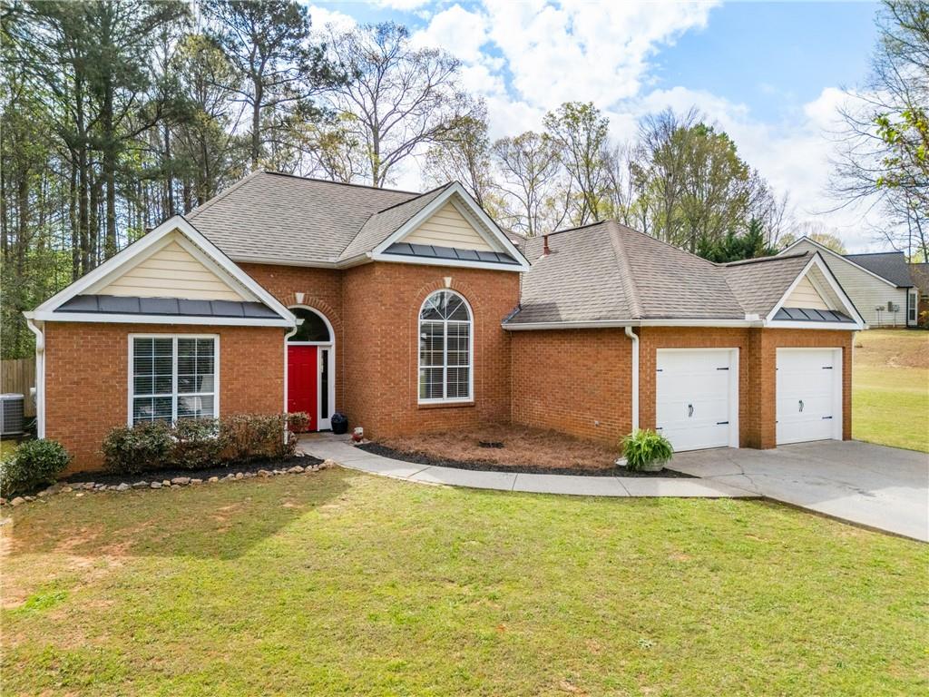 174 Foxtail Pass Acworth, GA 30101 - Photo 2 of 38 a front view of a house with a yard and garage
