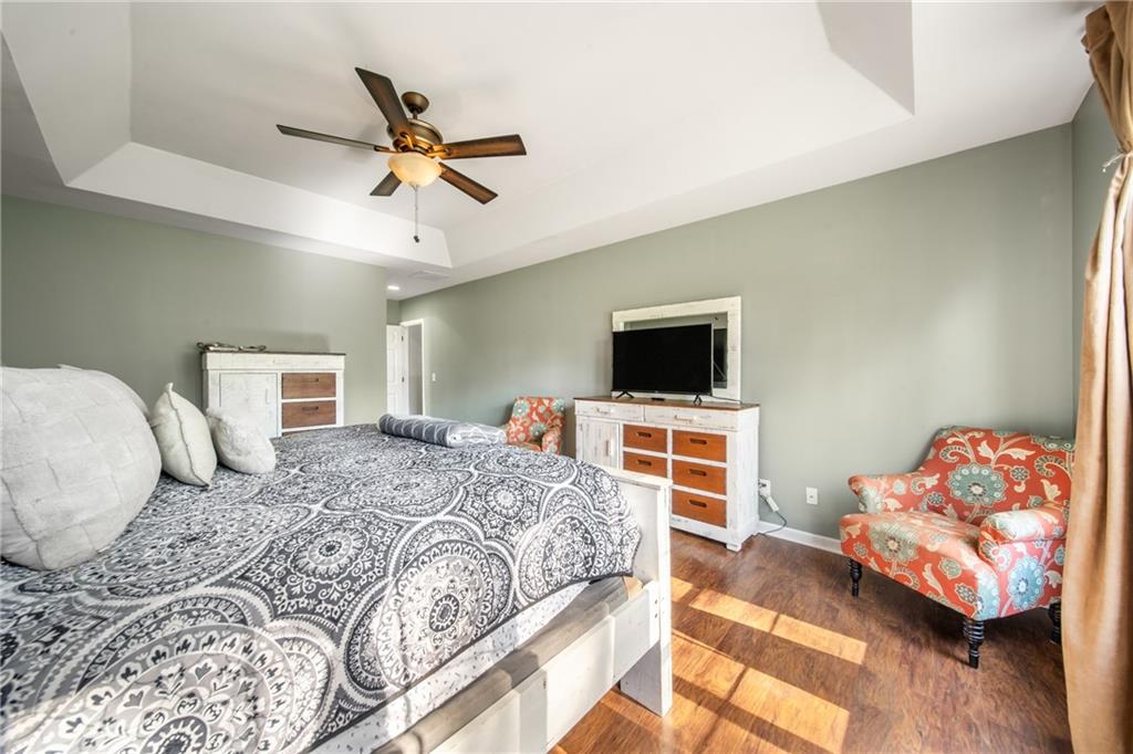 174 Foxtail Pass Acworth, GA 30101 - Photo 23 of 38 a bedroom with a bed and wooden floor