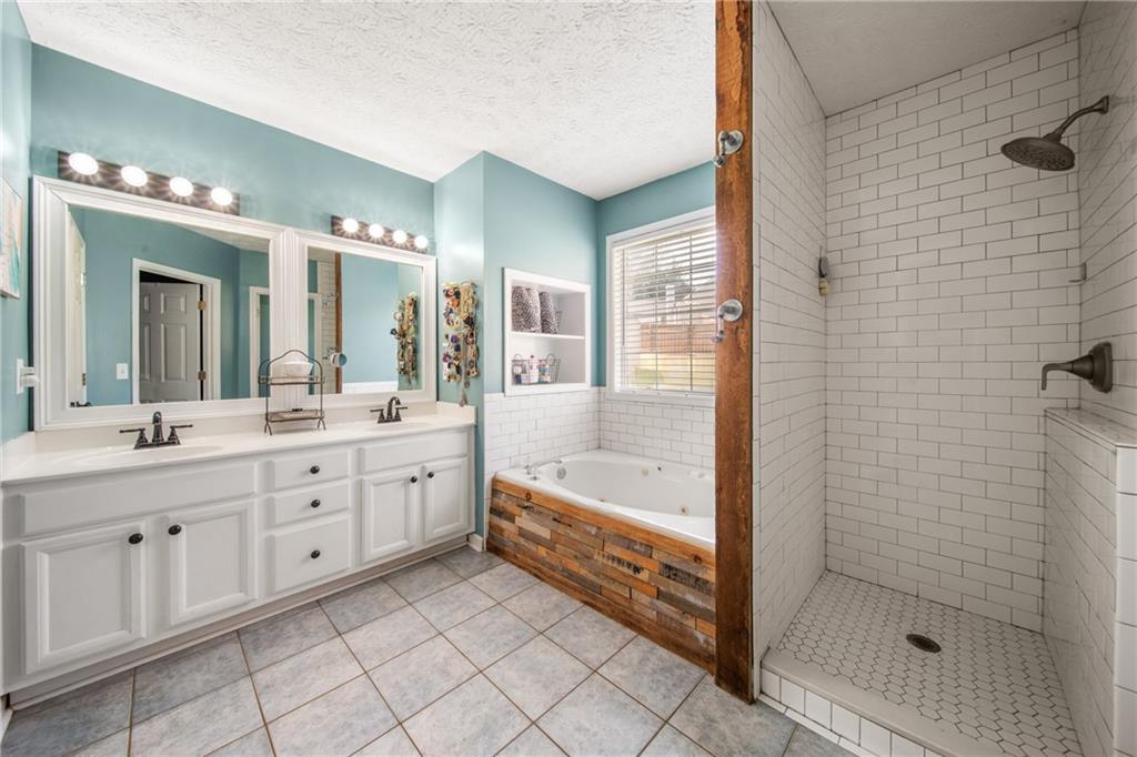 174 Foxtail Pass Acworth, GA 30101 - Photo 26 of 38 a bathroom with a double vanity sink mirror and bathtub