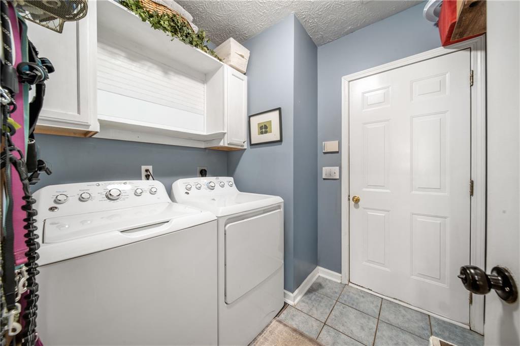 174 Foxtail Pass Acworth, GA 30101 - Photo 27 of 38 a utility room with dryer and washer