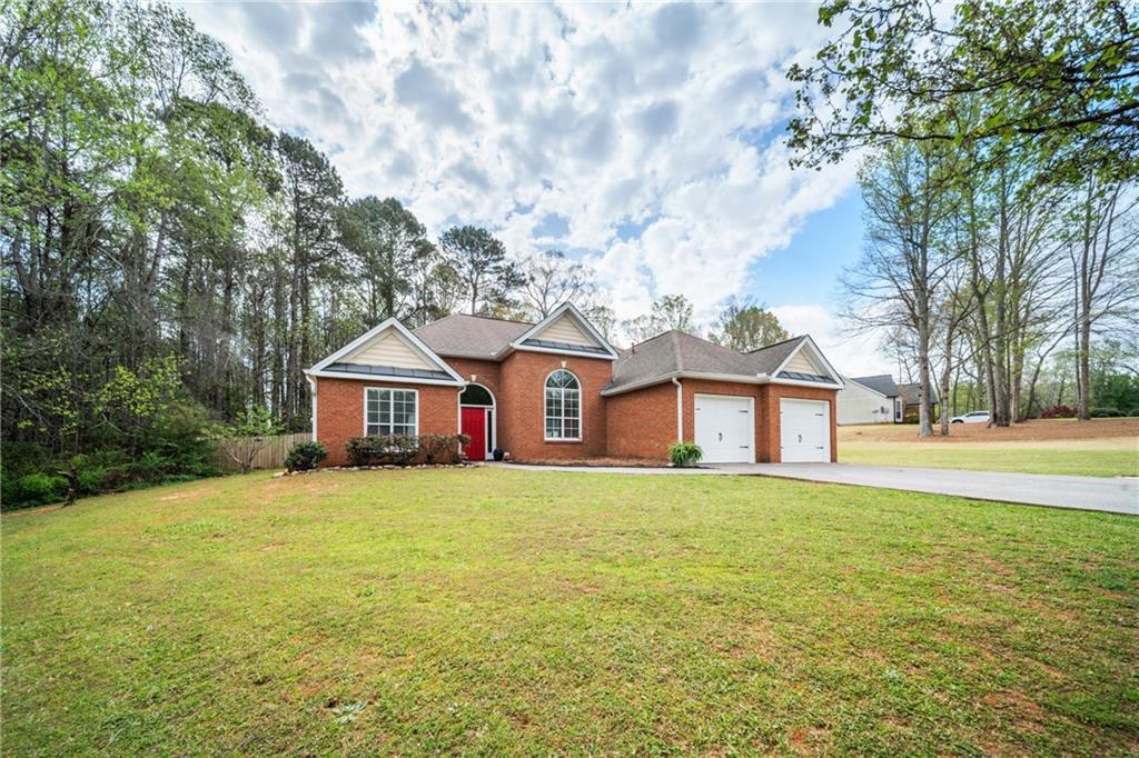 174 Foxtail Pass Acworth, GA 30101 - Photo 3 of 38 a large house with a big yard and large trees