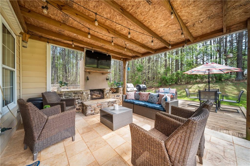 174 Foxtail Pass Acworth, GA 30101 - Photo 32 of 38 a outdoor space with patio couches under an umbrella