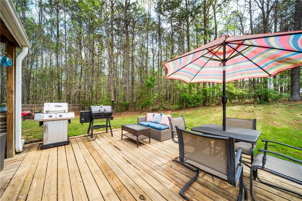 174 Foxtail Pass Acworth, GA 30101 - Photo 34 of 38 an outdoor sitting area with furniture and umbrella