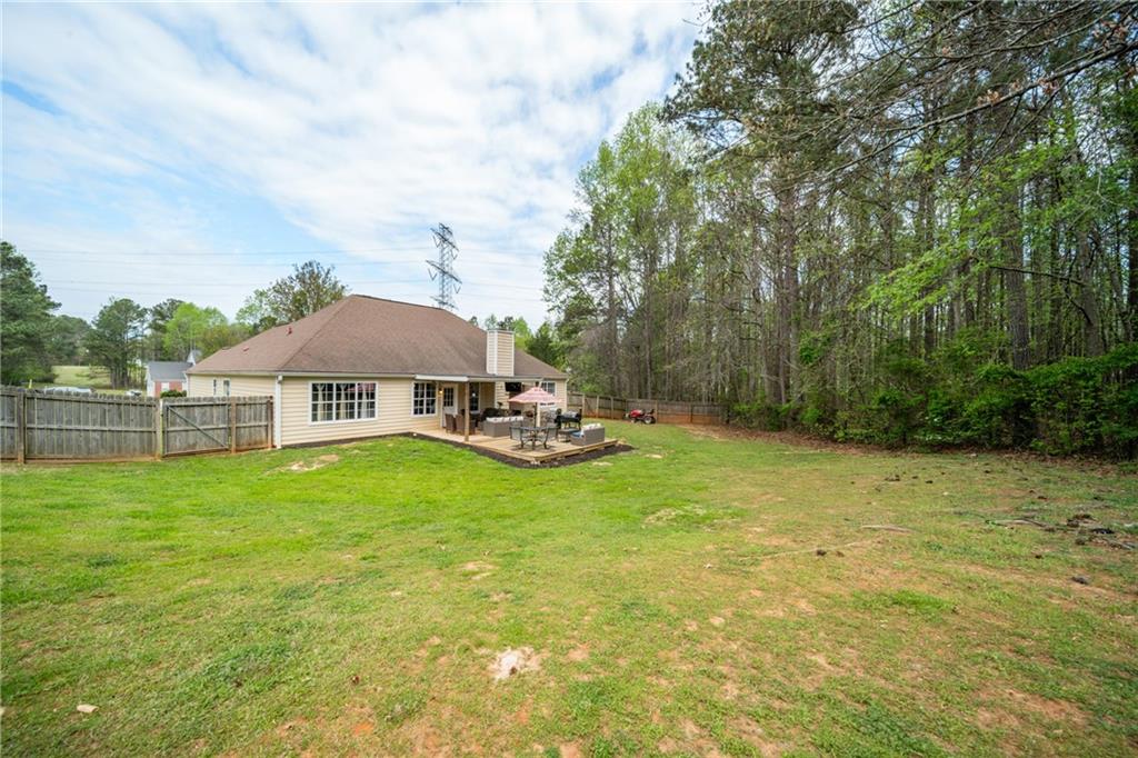 174 Foxtail Pass Acworth, GA 30101 - Photo 36 of 38 a backyard of a house with table and chairs