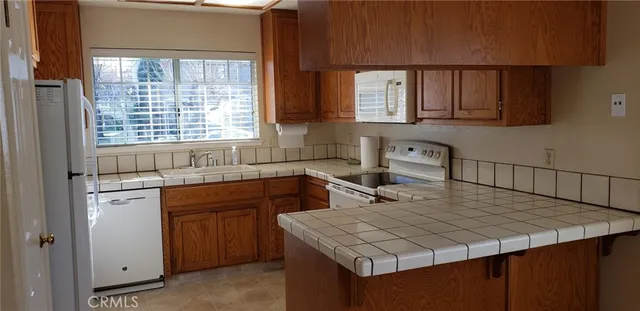 a kitchen with a sink a stove and cabinets