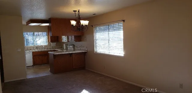 a kitchen with a chandelier and window