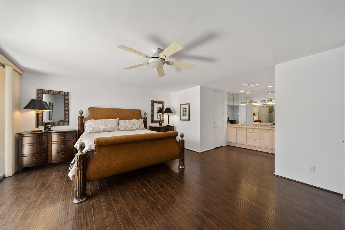 76895 Lark Drive Indian Wells, CA 92210 - Photo 12 of 25 a bedroom with a bed and a chandelier