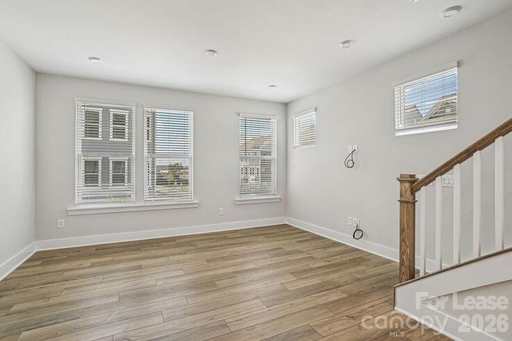 4375 Raleigh Street, Unit C1 Charlotte, NC 28213 - Photo 10 of 19 a view of an empty room with wooden floor and a window
