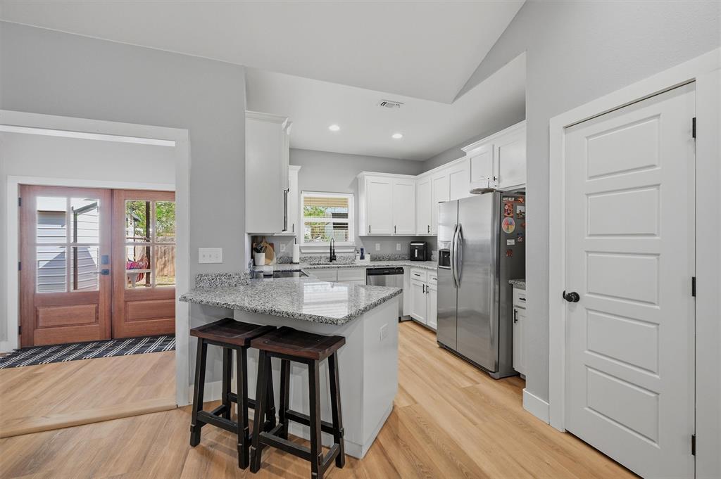 501 Bonham Street Tom Bean, TX 75491 - Photo 11 of 40 a kitchen with refrigerator a sink and cabinets