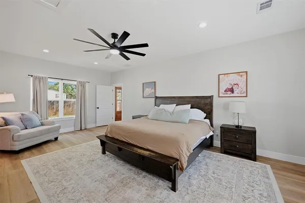 a spacious bedroom with a bed and couch