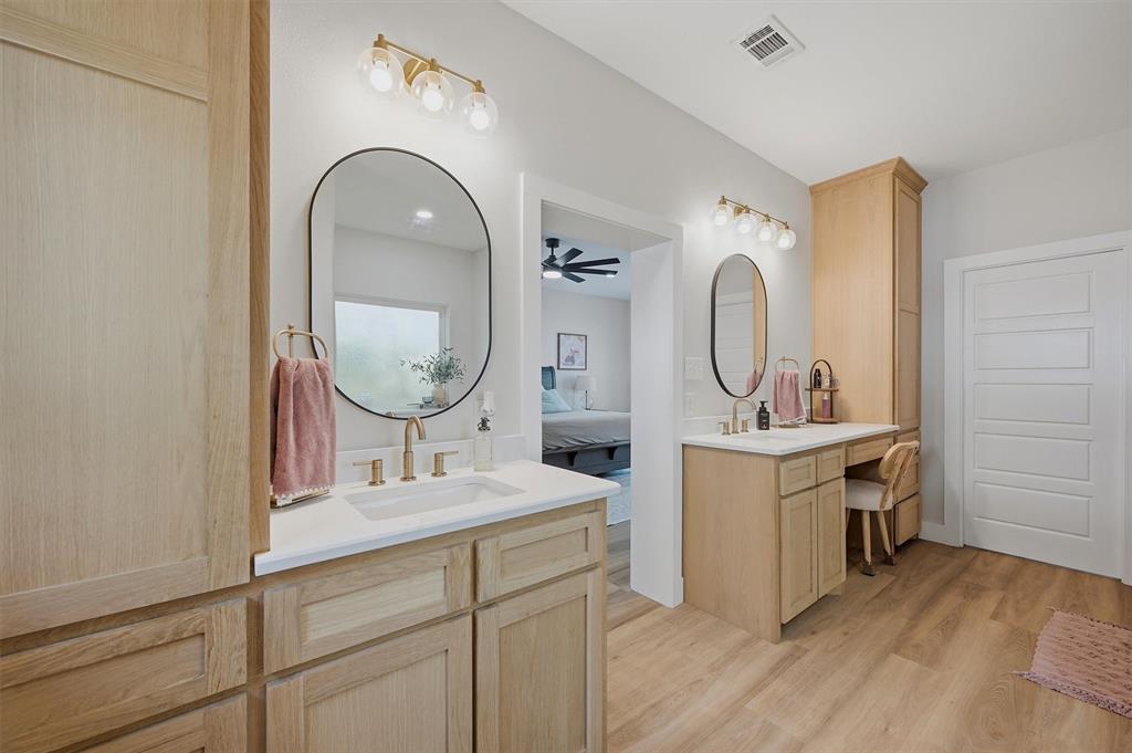 501 Bonham Street Tom Bean, TX 75491 - Photo 18 of 40 a bathroom with a double vanity sink and a mirror