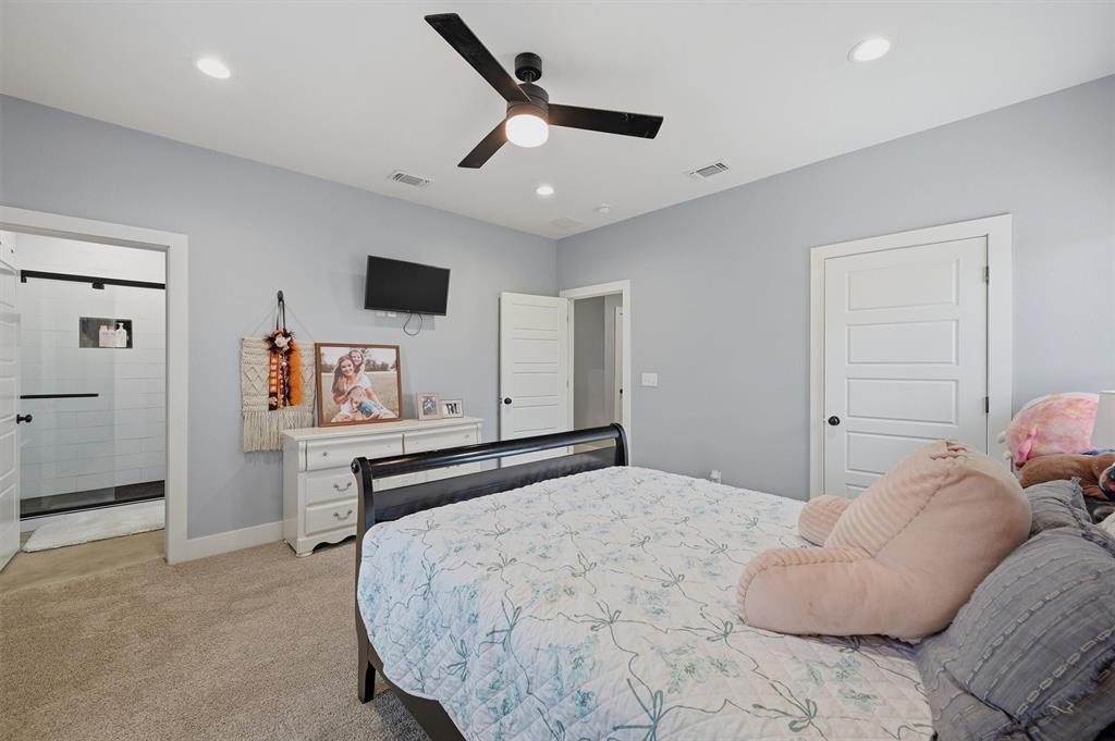 501 Bonham Street Tom Bean, TX 75491 - Photo 23 of 40 a bedroom with a bed and a large mirror