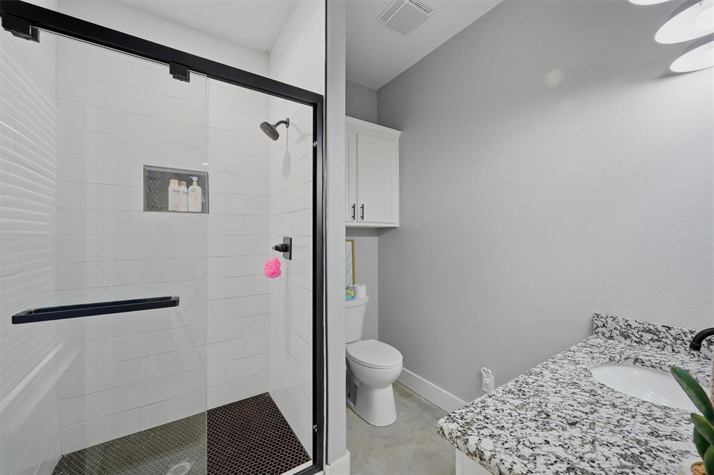 501 Bonham Street Tom Bean, TX 75491 - Photo 24 of 40 a bathroom with a toilet sink and shower