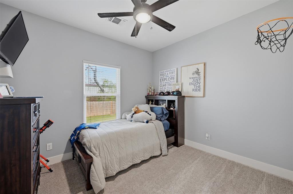 501 Bonham Street Tom Bean, TX 75491 - Photo 28 of 40 a bedroom with a bed and a flat tv screen