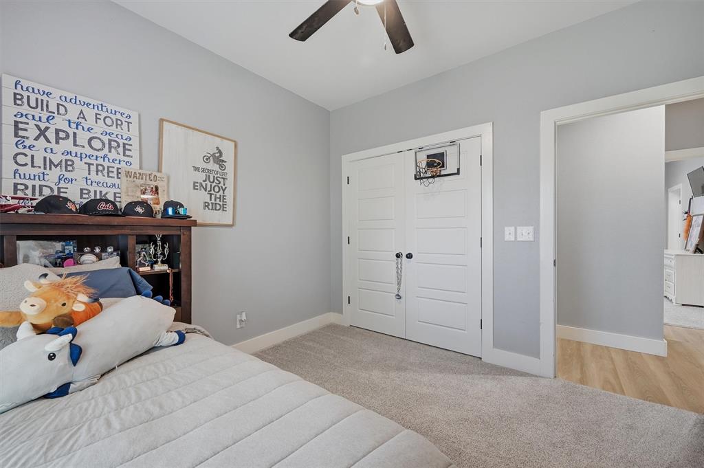 501 Bonham Street Tom Bean, TX 75491 - Photo 29 of 40 a bedroom with a bed and a chandelier