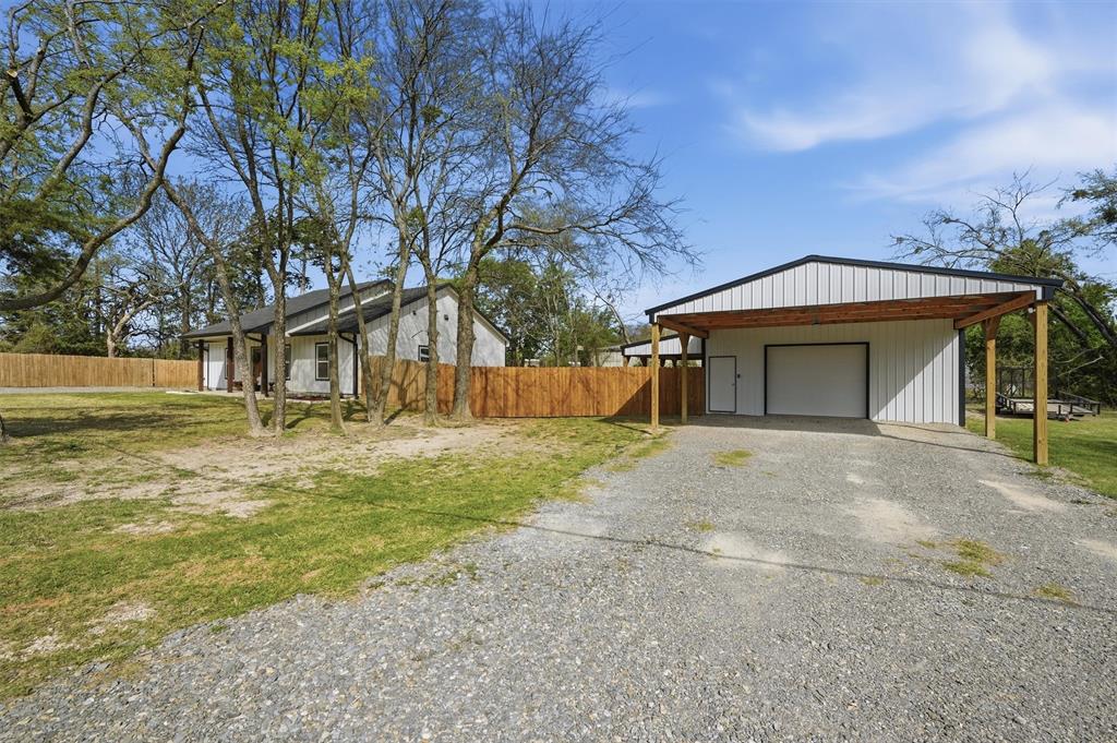 501 Bonham Street Tom Bean, TX 75491 - Photo 3 of 40 a front view of a house with a yard and garage