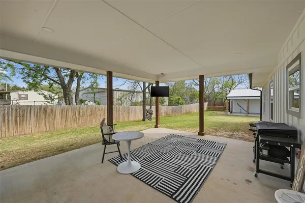 a view of a patio with a yard