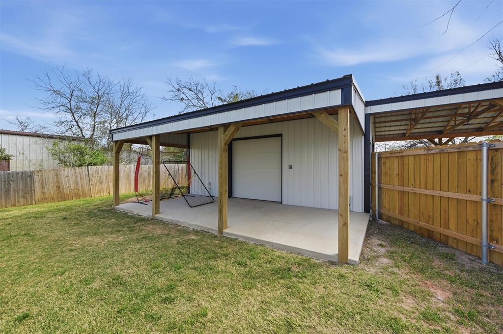 501 Bonham Street Tom Bean, TX 75491 - Photo 36 of 40 a backyard of a house with a garage and yard