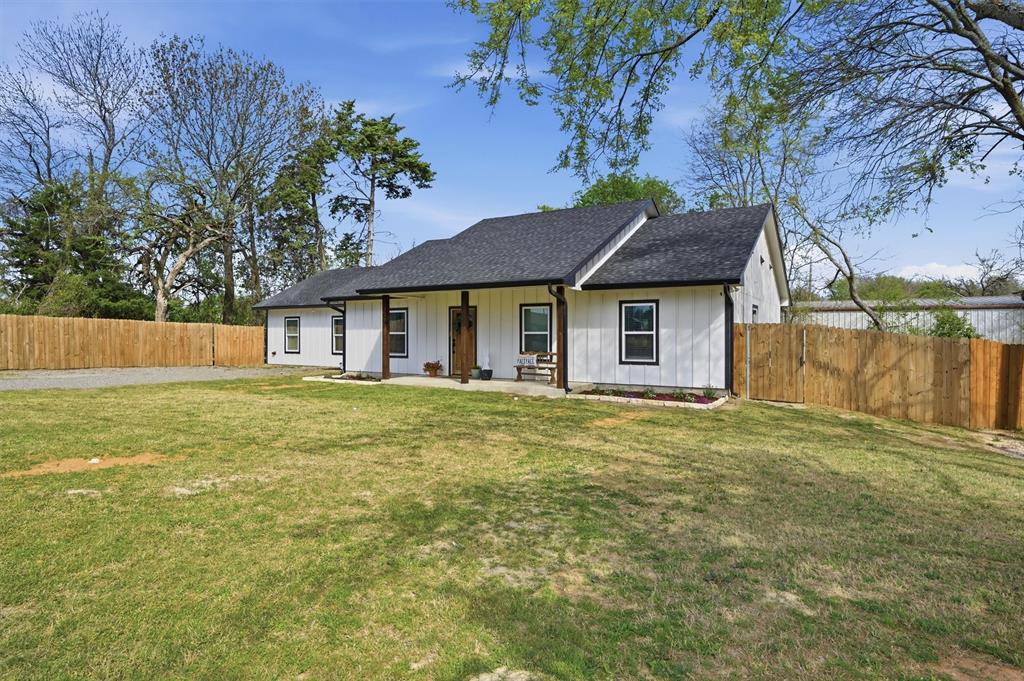 501 Bonham Street Tom Bean, TX 75491 - Photo 5 of 40 a front view of a house with a garden