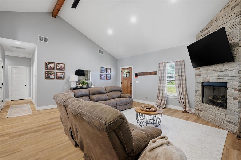 501 Bonham Street Tom Bean, TX 75491 - Photo 7 of 40 a living room with furniture and a flat screen tv