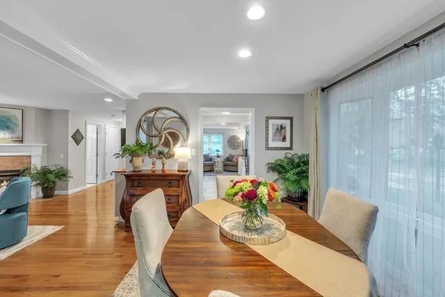 a living room with furniture a potted plant and kitchen view