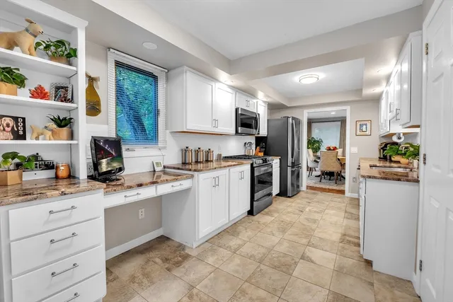 a kitchen with a sink window and cabinets