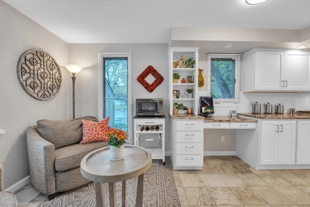 a living room with granite countertop furniture and a fireplace