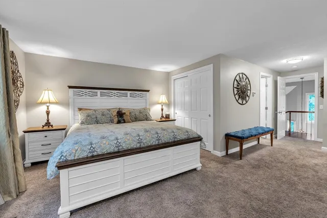 a bedroom with a bed and a lamp on table